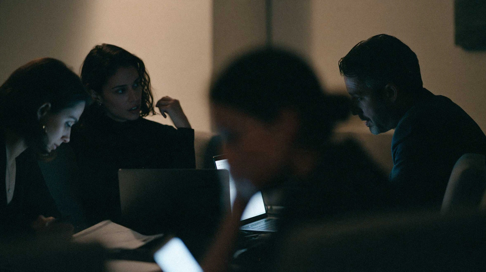 A team working together around a laptop during an AltAcademy session